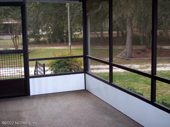 110 Bayberry Road Georgetown, FL 32139 - Photo 15 of 17 a view of a glass room with a floor to ceiling window next to a yard