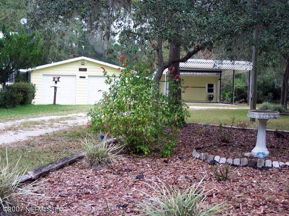 110 Bayberry Road Georgetown, FL 32139 - Photo 2 of 17 a front view of a house with garden