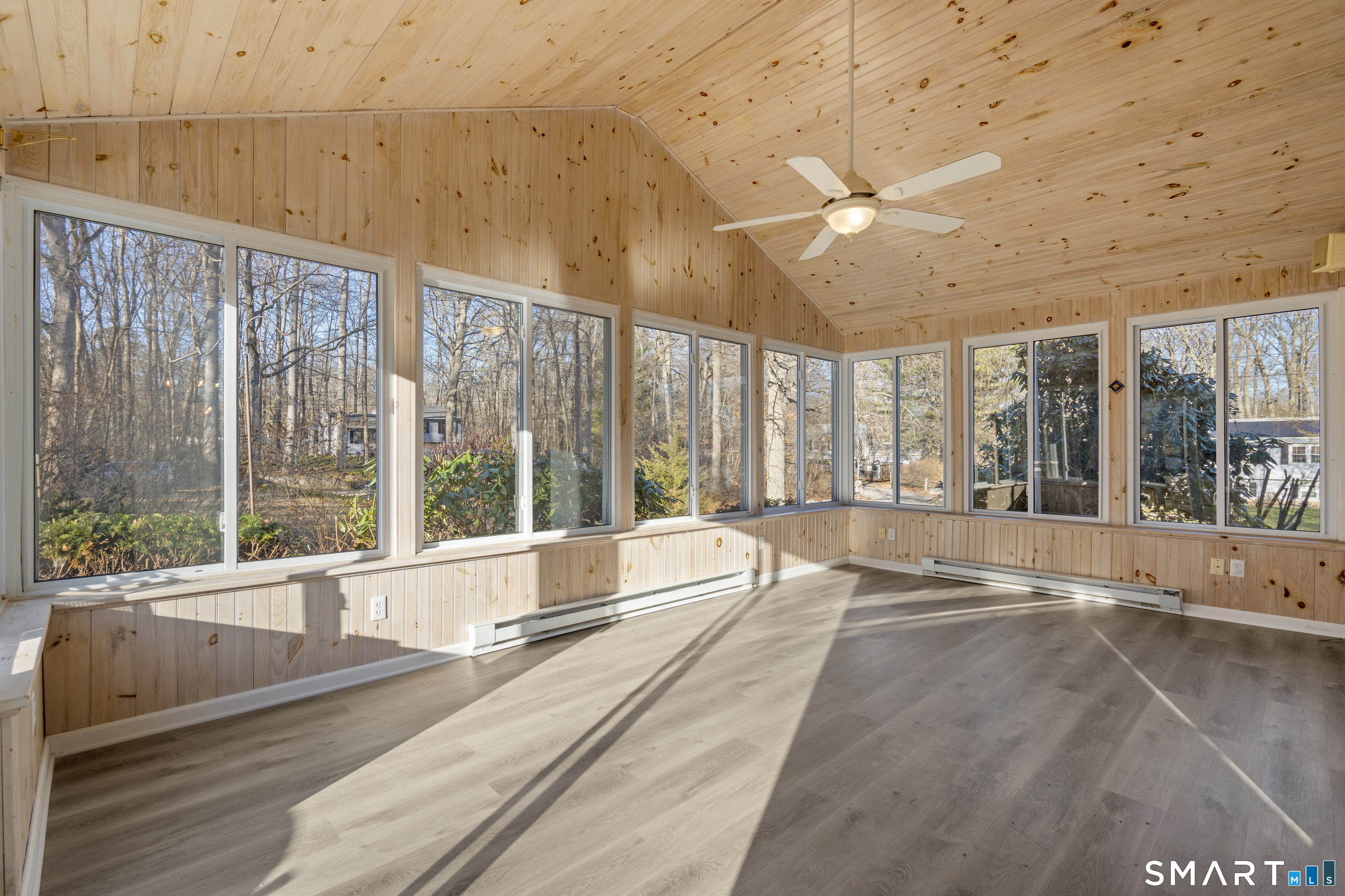 7 Coach Light Drive Clinton, CT 06413 - Photo 19 of 26 a view of an empty room with a floor to ceiling window and an outdoor view