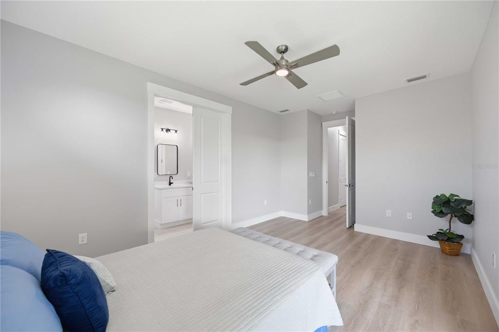 10443 Riverside Road Port Charlotte, FL 33981 - Photo 18 of 64 a bedroom with a bed and a potted plant on the dresser