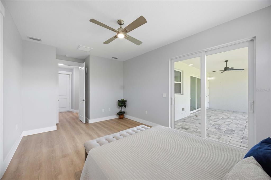 10443 Riverside Road Port Charlotte, FL 33981 - Photo 19 of 64 a bedroom with a bed and a chandelier