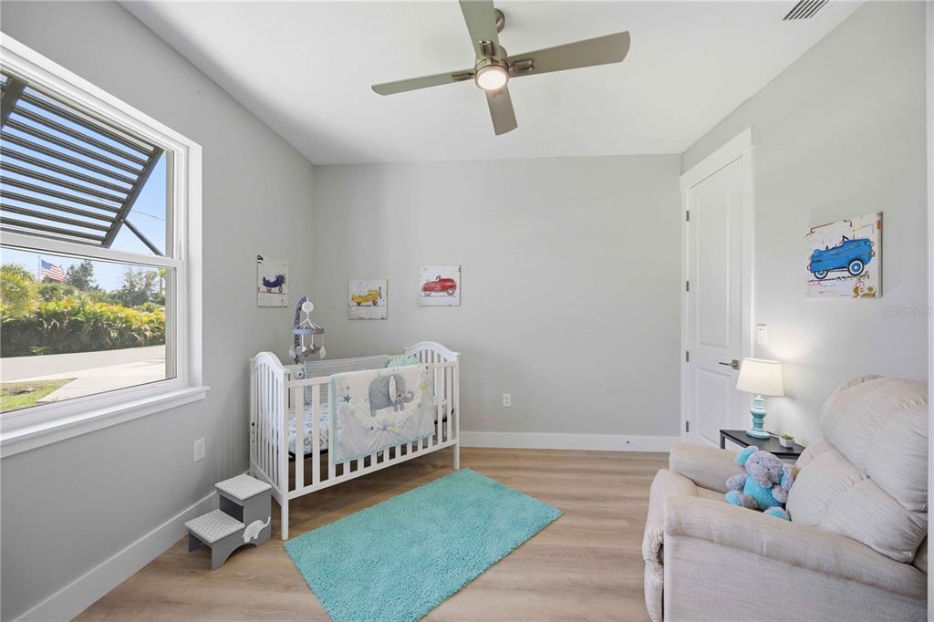 10443 Riverside Road Port Charlotte, FL 33981 - Photo 28 of 64 a bedroom with a bed and a window