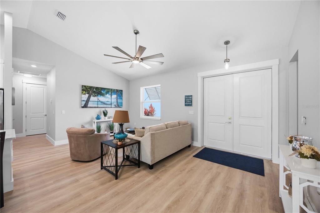 10443 Riverside Road Port Charlotte, FL 33981 - Photo 3 of 64 a living room with furniture and a wooden floor