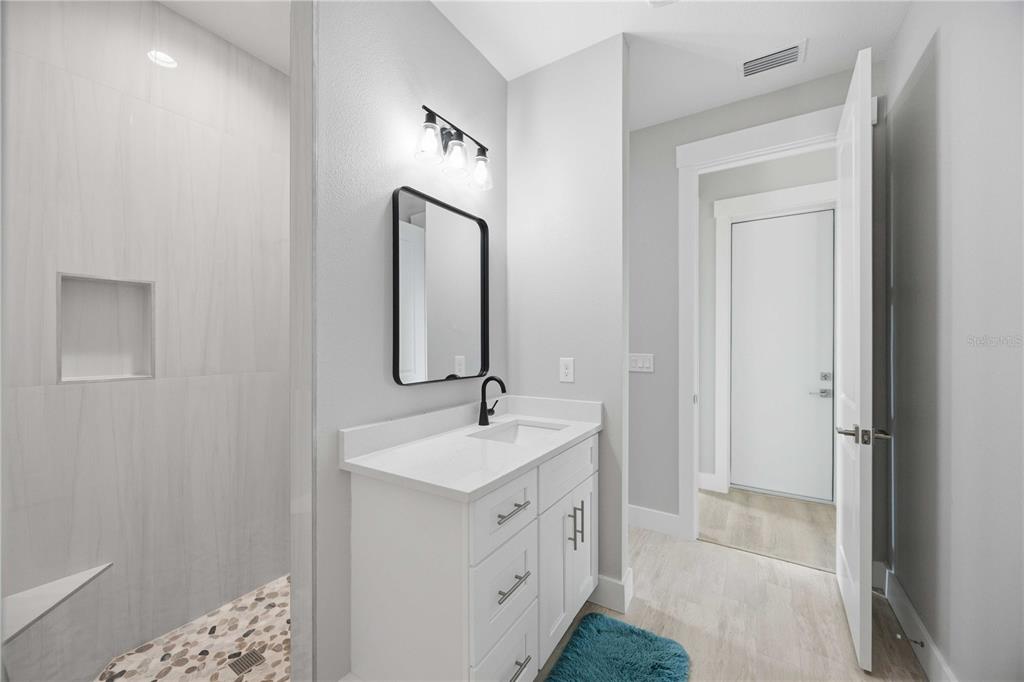 10443 Riverside Road Port Charlotte, FL 33981 - Photo 31 of 64 a spacious bathroom with a double vanity sink and mirror
