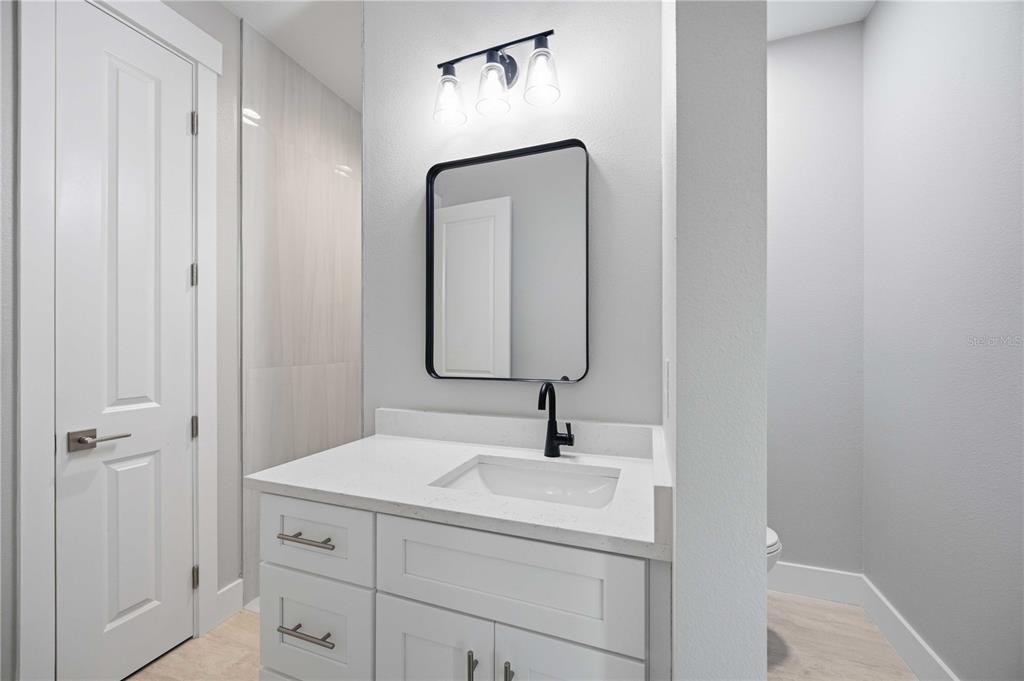 10443 Riverside Road Port Charlotte, FL 33981 - Photo 33 of 64 a bathroom with a sink and a mirror