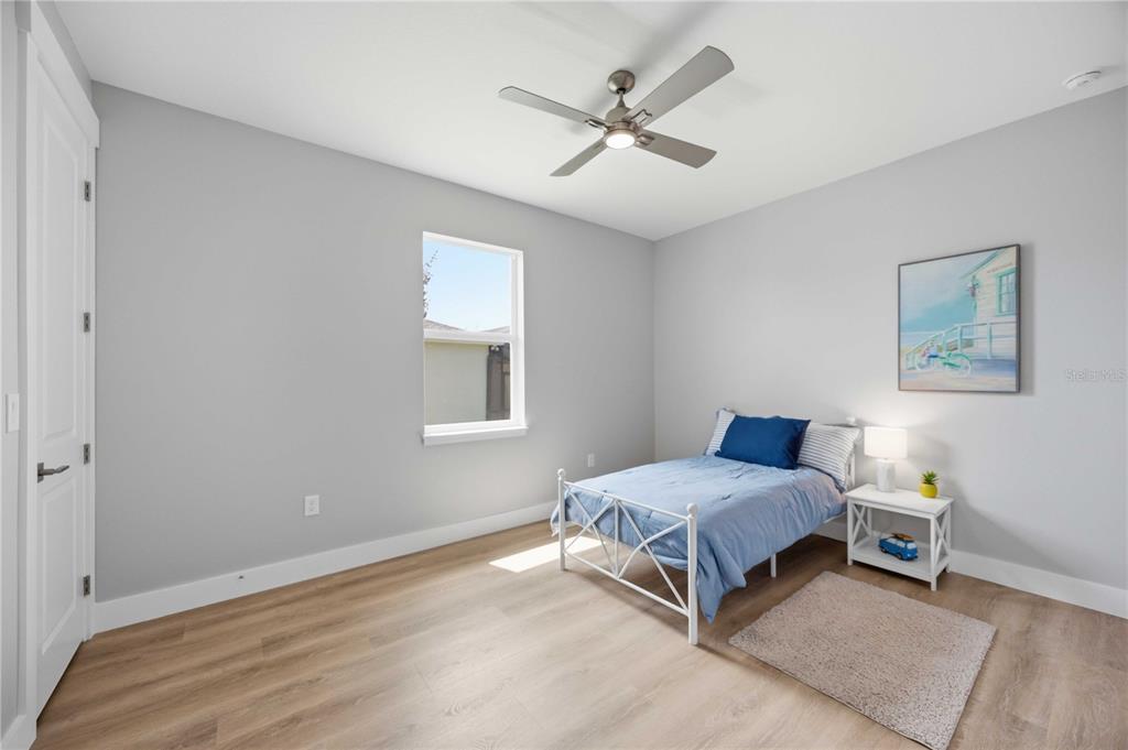 10443 Riverside Road Port Charlotte, FL 33981 - Photo 34 of 64 a living room with a bed furniture and a window