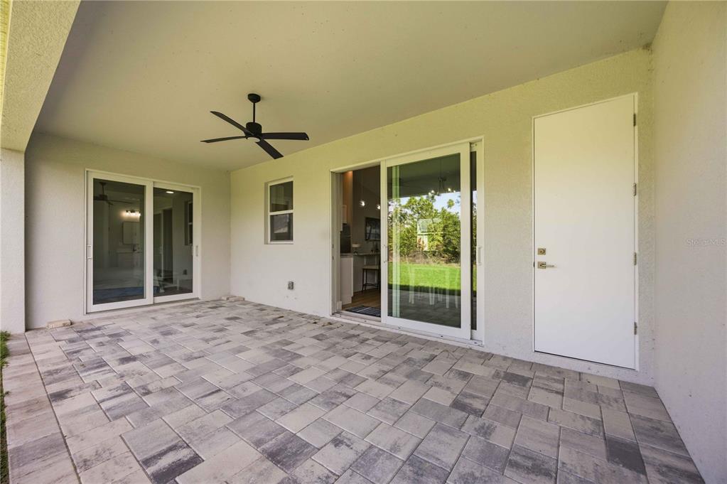 10443 Riverside Road Port Charlotte, FL 33981 - Photo 40 of 64 a view of a big room with windows and chandelier fan