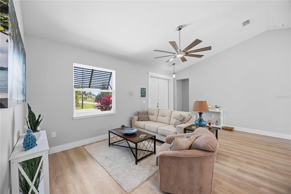 10443 Riverside Road Port Charlotte, FL 33981 - Photo 4 of 64 a living room with furniture and a window