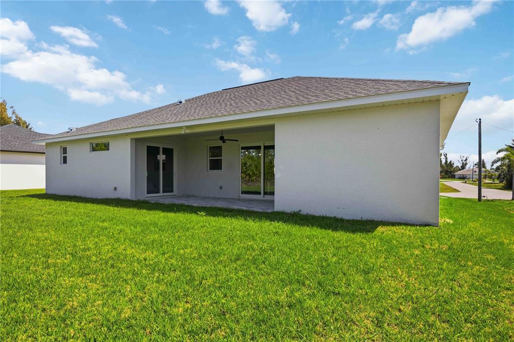 10443 Riverside Road Port Charlotte, FL 33981 - Photo 43 of 64 a backyard of a house with lots of green space