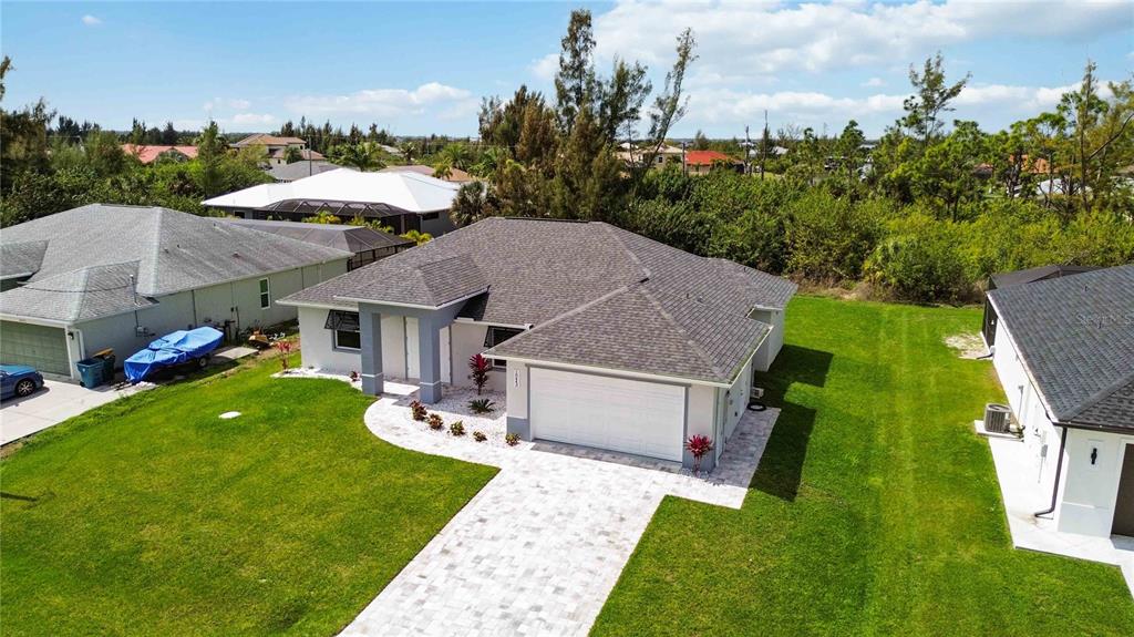 10443 Riverside Road Port Charlotte, FL 33981 - Photo 45 of 64 a aerial view of a house with swimming pool and big yard
