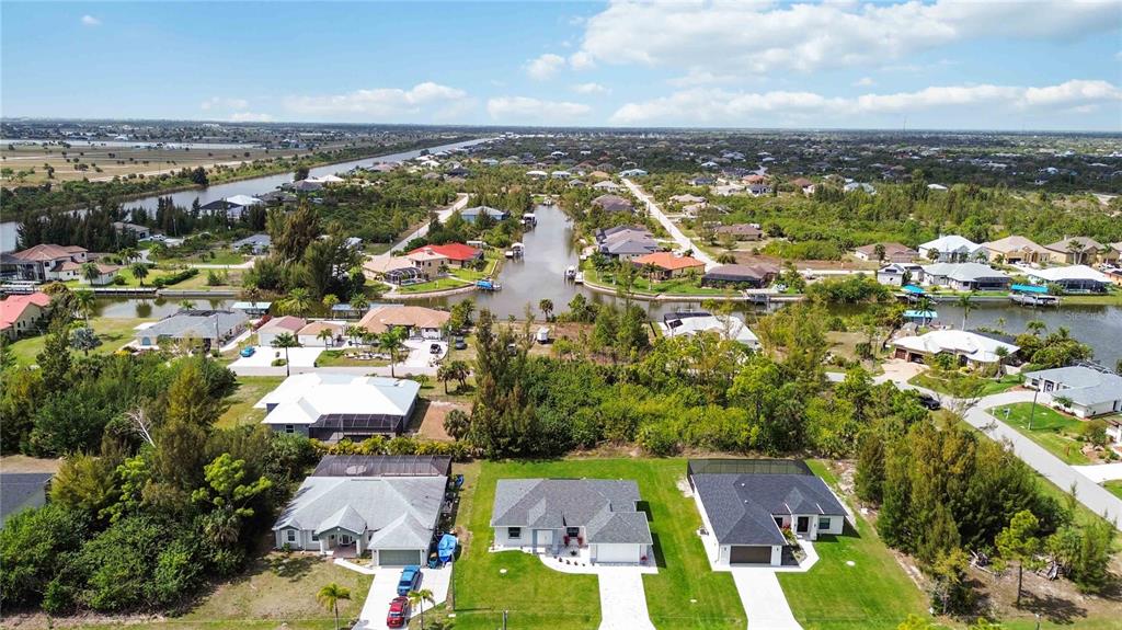 10443 Riverside Road Port Charlotte, FL 33981 - Photo 48 of 64 an aerial view of residential houses with outdoor space