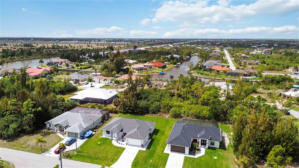 10443 Riverside Road Port Charlotte, FL 33981 - Photo 49 of 64 an aerial view of residential houses with outdoor space