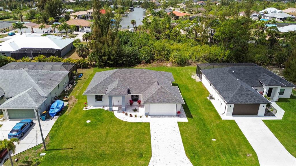 10443 Riverside Road Port Charlotte, FL 33981 - Photo 51 of 64 an aerial view of a house with swimming pool garden and patio