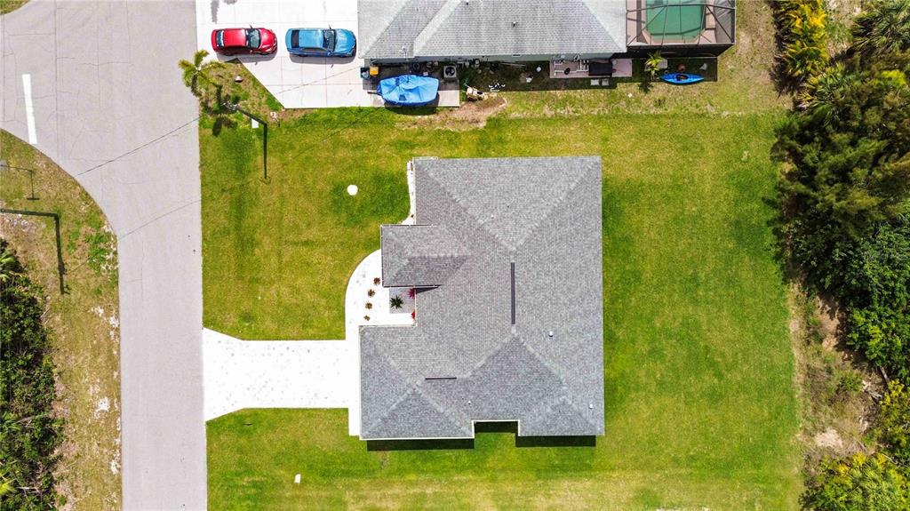 10443 Riverside Road Port Charlotte, FL 33981 - Photo 52 of 64 a aerial view of a house with a swimming pool