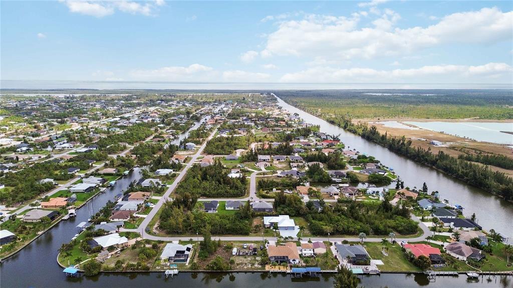 10443 Riverside Road Port Charlotte, FL 33981 - Photo 58 of 64 an aerial view of residential houses with outdoor space