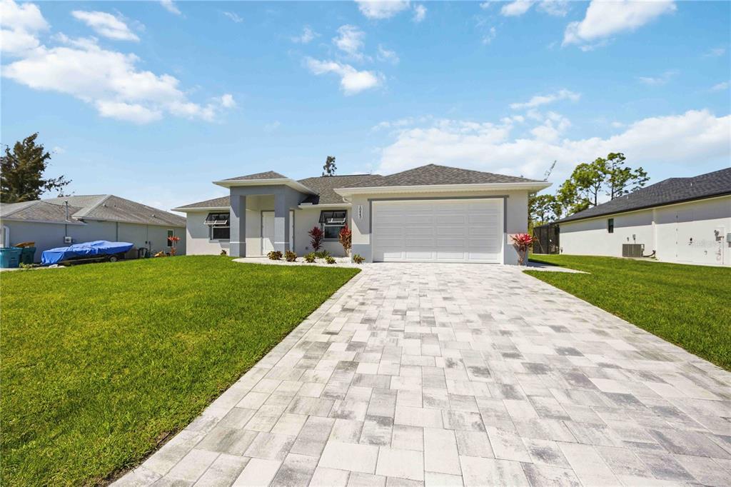 10443 Riverside Road Port Charlotte, FL 33981 - Photo 60 of 64 a front view of house with yard and green space