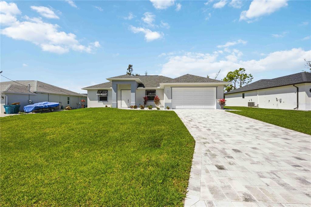 10443 Riverside Road Port Charlotte, FL 33981 - Photo 61 of 64 a front view of a house with garden