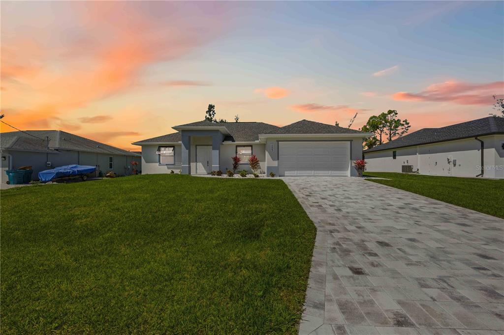 10443 Riverside Road Port Charlotte, FL 33981 - Photo 62 of 64 a front view of a house with a garden