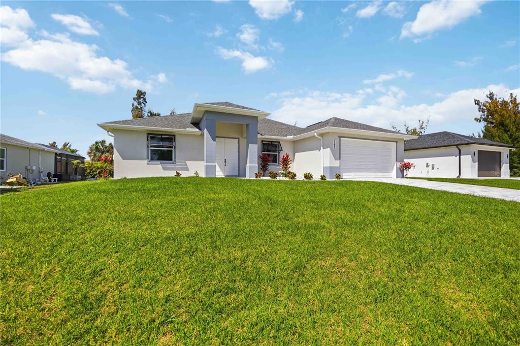 10443 Riverside Road Port Charlotte, FL 33981 - Photo 63 of 64 a view of a house with a big yard and large trees