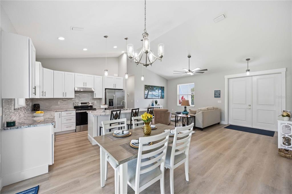 10443 Riverside Road Port Charlotte, FL 33981 - Photo 9 of 64 a view of a dining room with furniture and wooden floor