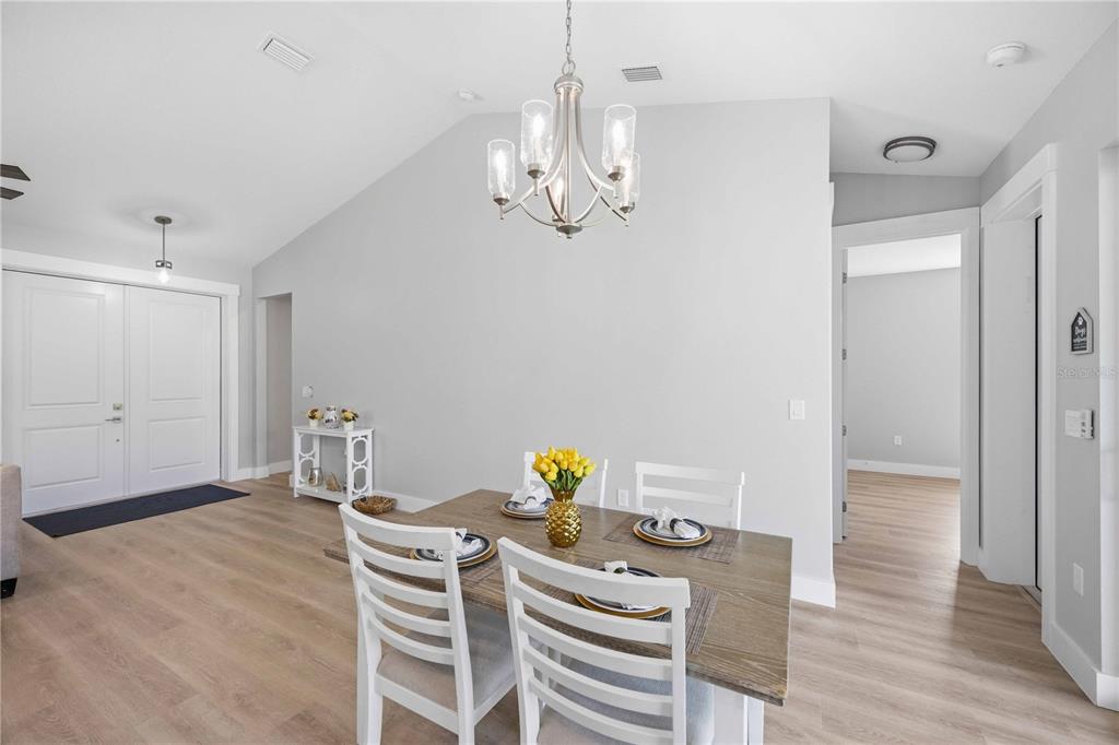 10443 Riverside Road Port Charlotte, FL 33981 - Photo 10 of 64 a view of a dining room with furniture and wooden floor