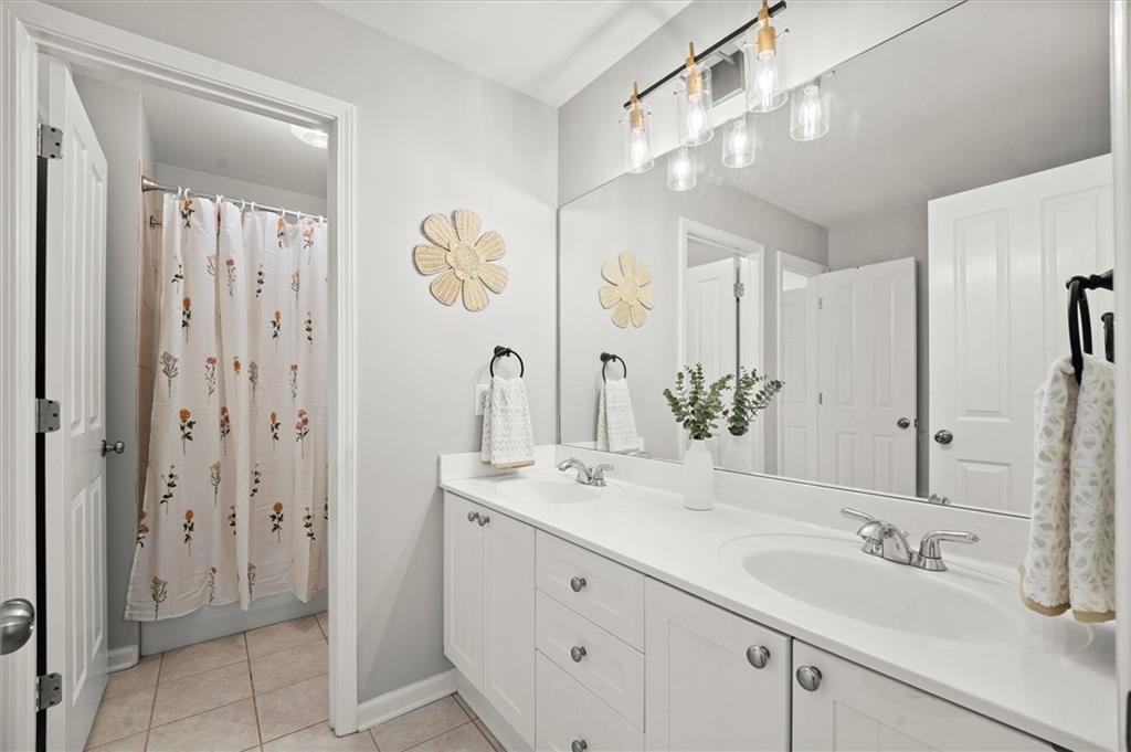 6229 Grand Loop Road Sugar Hill, GA 30518 - Photo 48 of 93 a bathroom with a double vanity sink mirror and double
