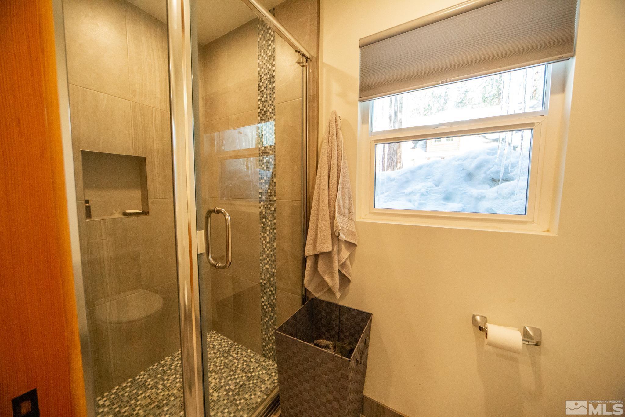 301 Cedar Drive Stateline, NV 89449 - Photo 11 of 27 a bathroom with a glass shower door