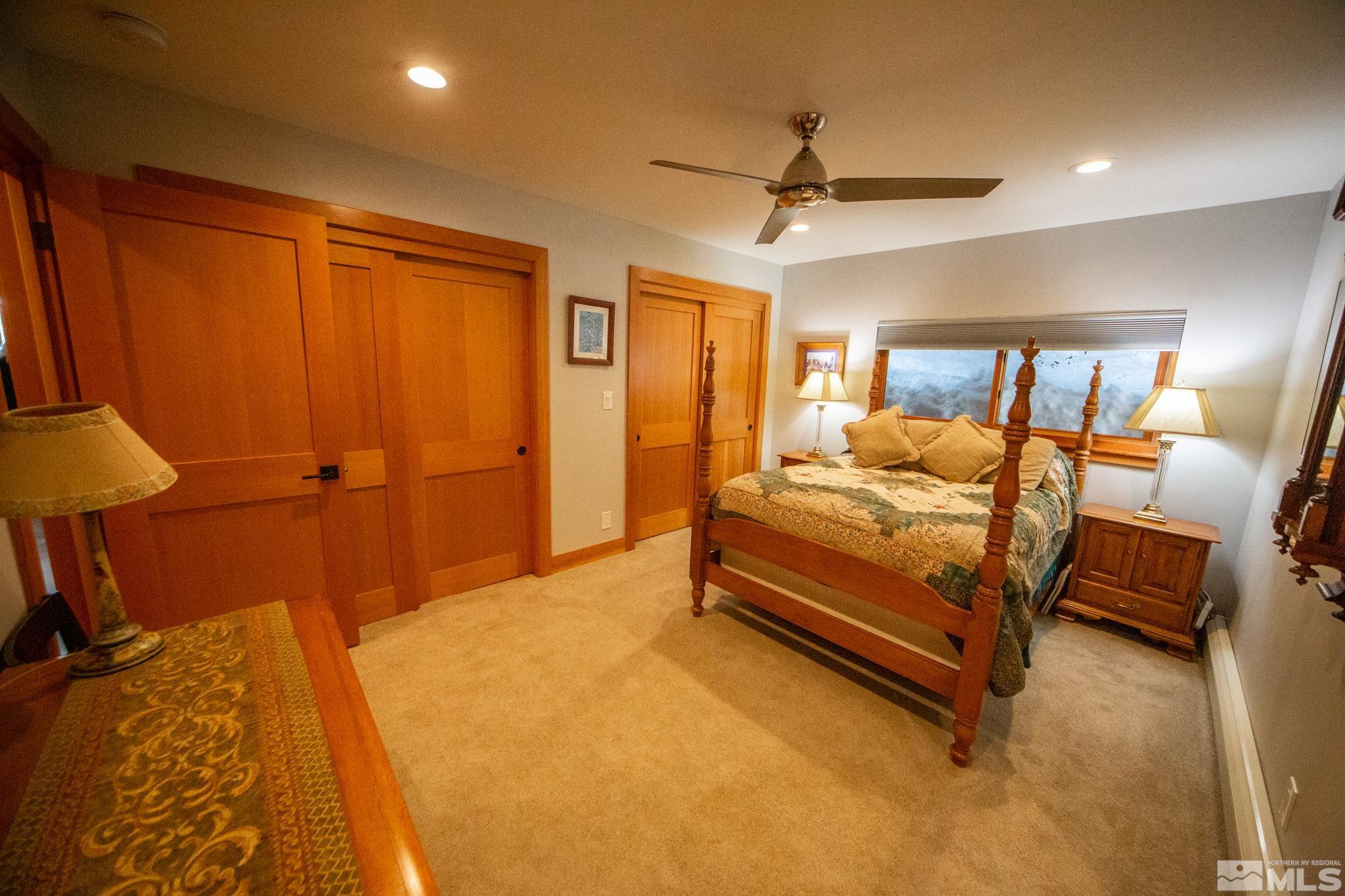 301 Cedar Drive Stateline, NV 89449 - Photo 13 of 27 a bedroom with a bed and a chandelier