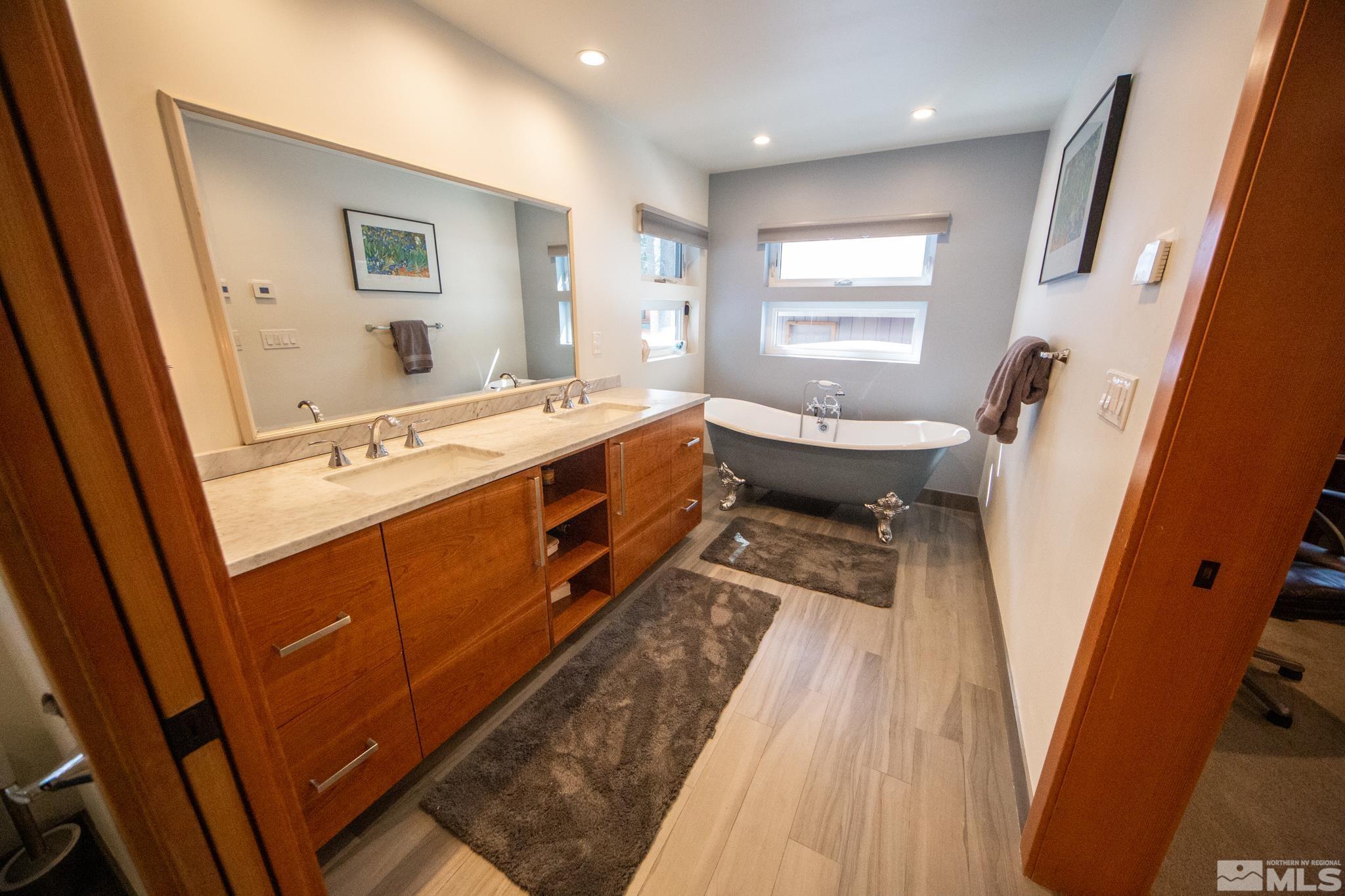 301 Cedar Drive Stateline, NV 89449 - Photo 19 of 27 a bathroom with a sink a bathtub and a window
