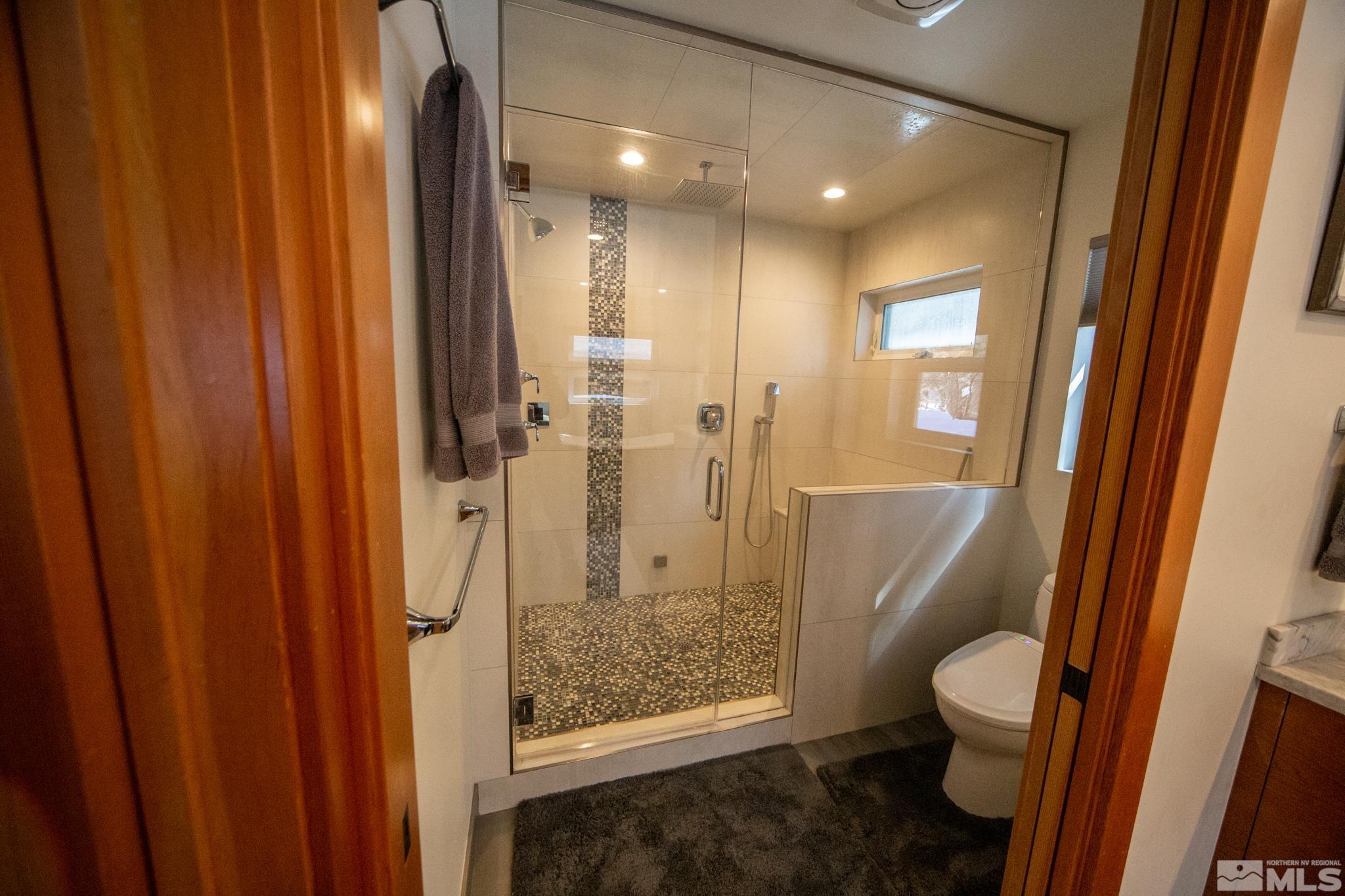 301 Cedar Drive Stateline, NV 89449 - Photo 20 of 27 a bathroom with a granite countertop toilet and a shower