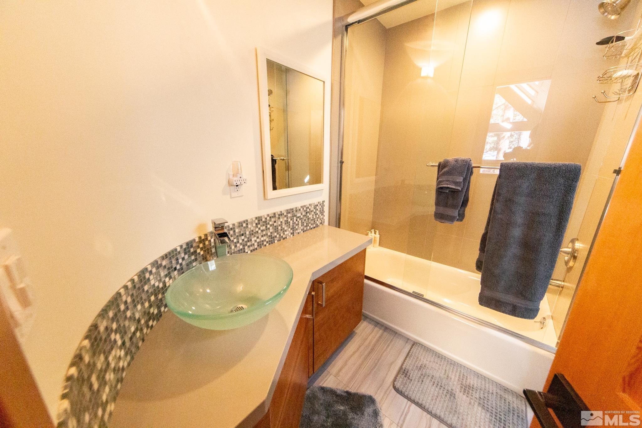 301 Cedar Drive Stateline, NV 89449 - Photo 24 of 27 a bathroom with a tub sink and mirror