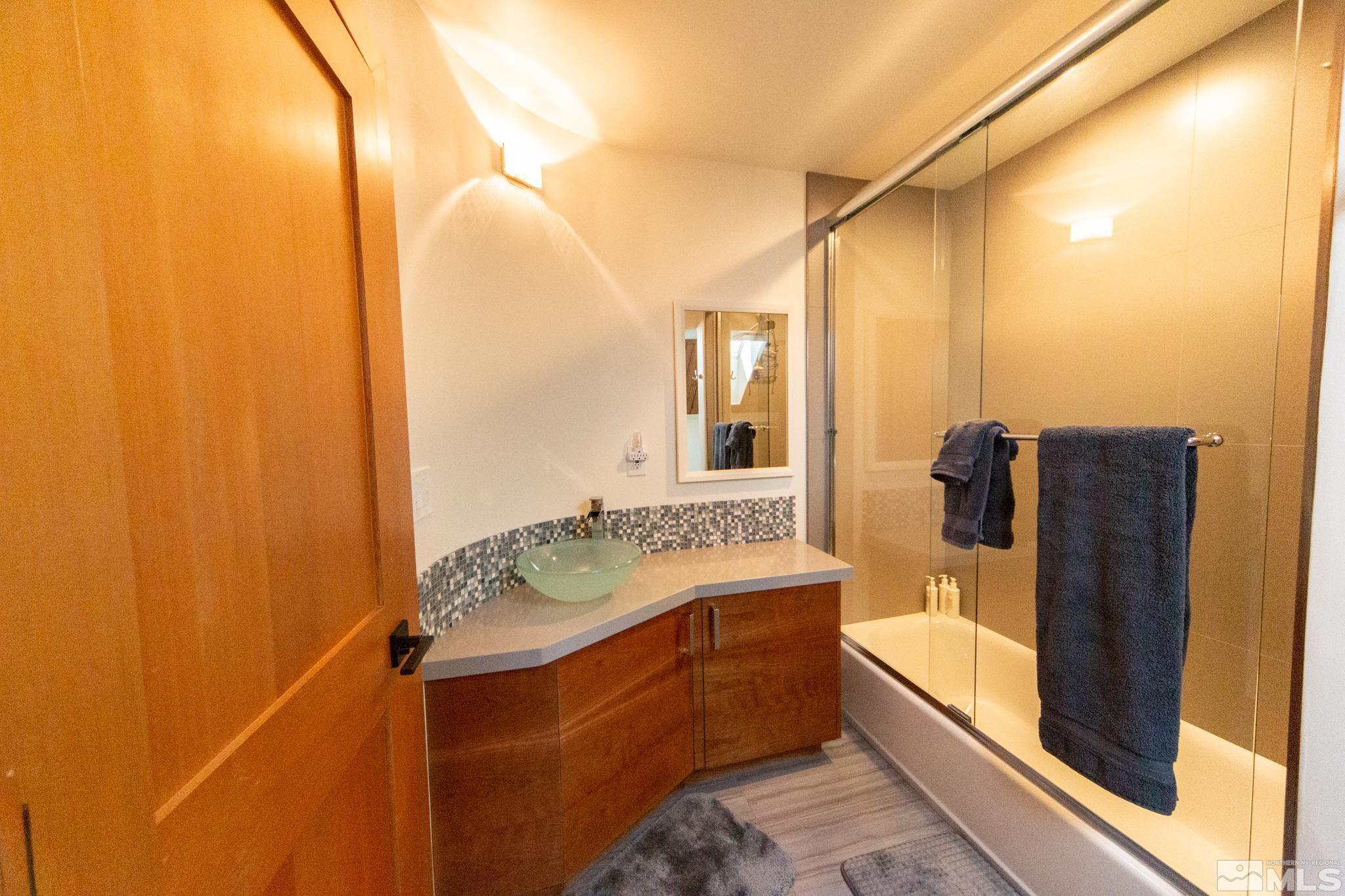 301 Cedar Drive Stateline, NV 89449 - Photo 25 of 27 a bathroom with a sink and mirror