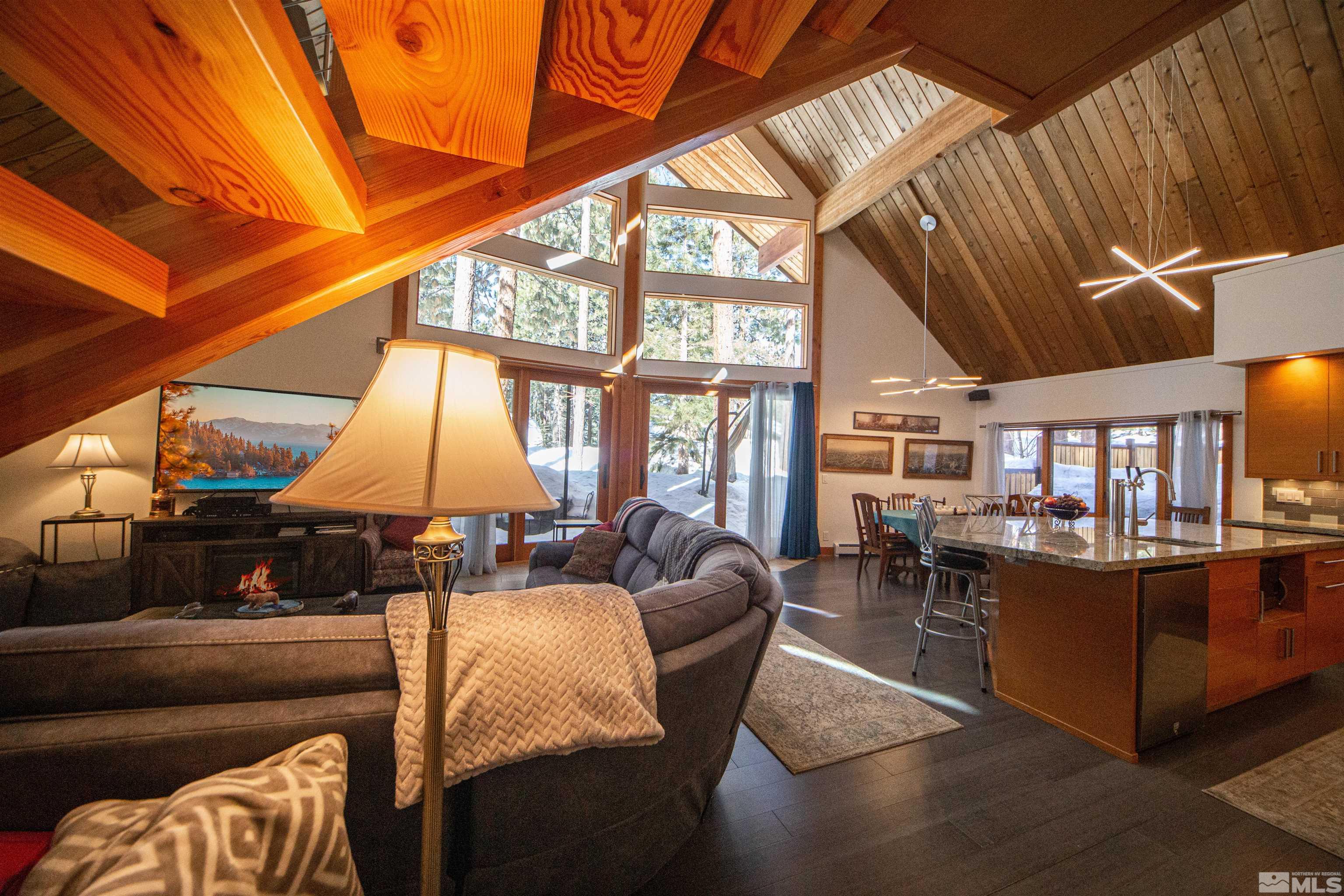 301 Cedar Drive Stateline, NV 89449 - Photo 4 of 27 a living room with furniture a large window and chandelier