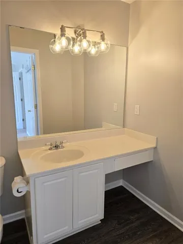 a bathroom with a sink vanity and a mirror