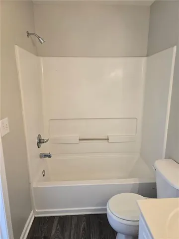 a bathroom with a toilet and a bathtub
