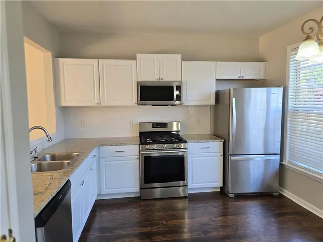 a kitchen with a sink stove and refrigerator