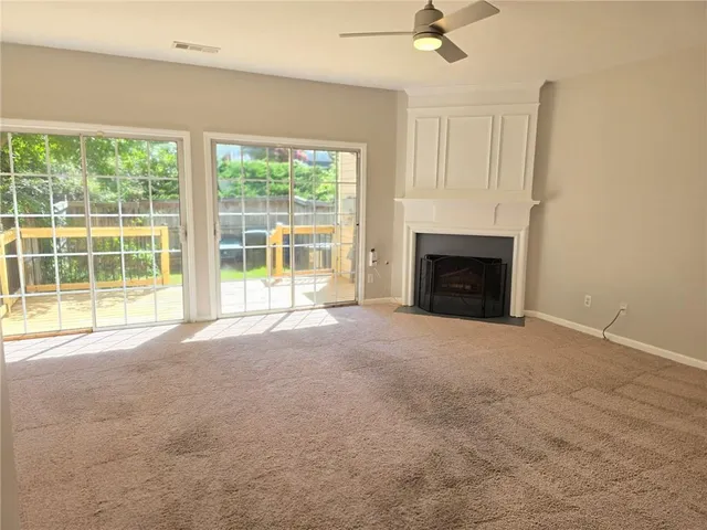 a view of empty room with a fireplace