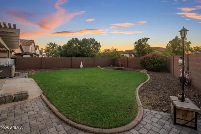a view of a swimming pool with a yard