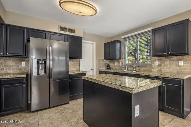 a kitchen with granite countertop stainless steel appliances and wooden cabinets
