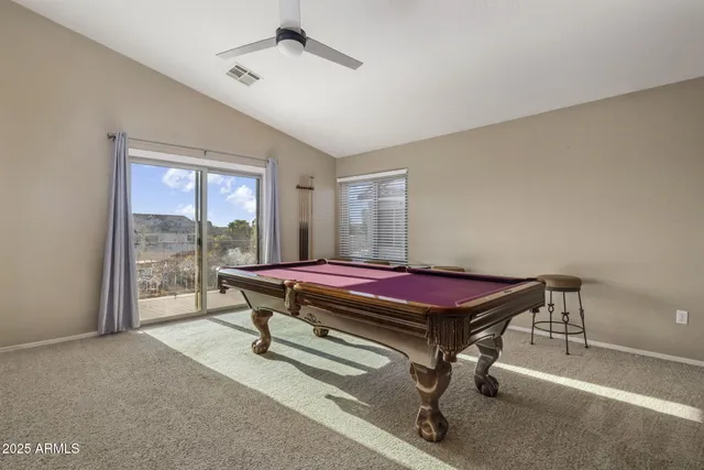 a living room with furniture and a ceiling fan