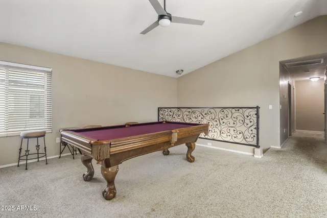 a room with pool table and windows