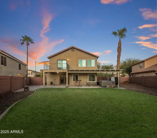 a view of a house with a yard and sitting area