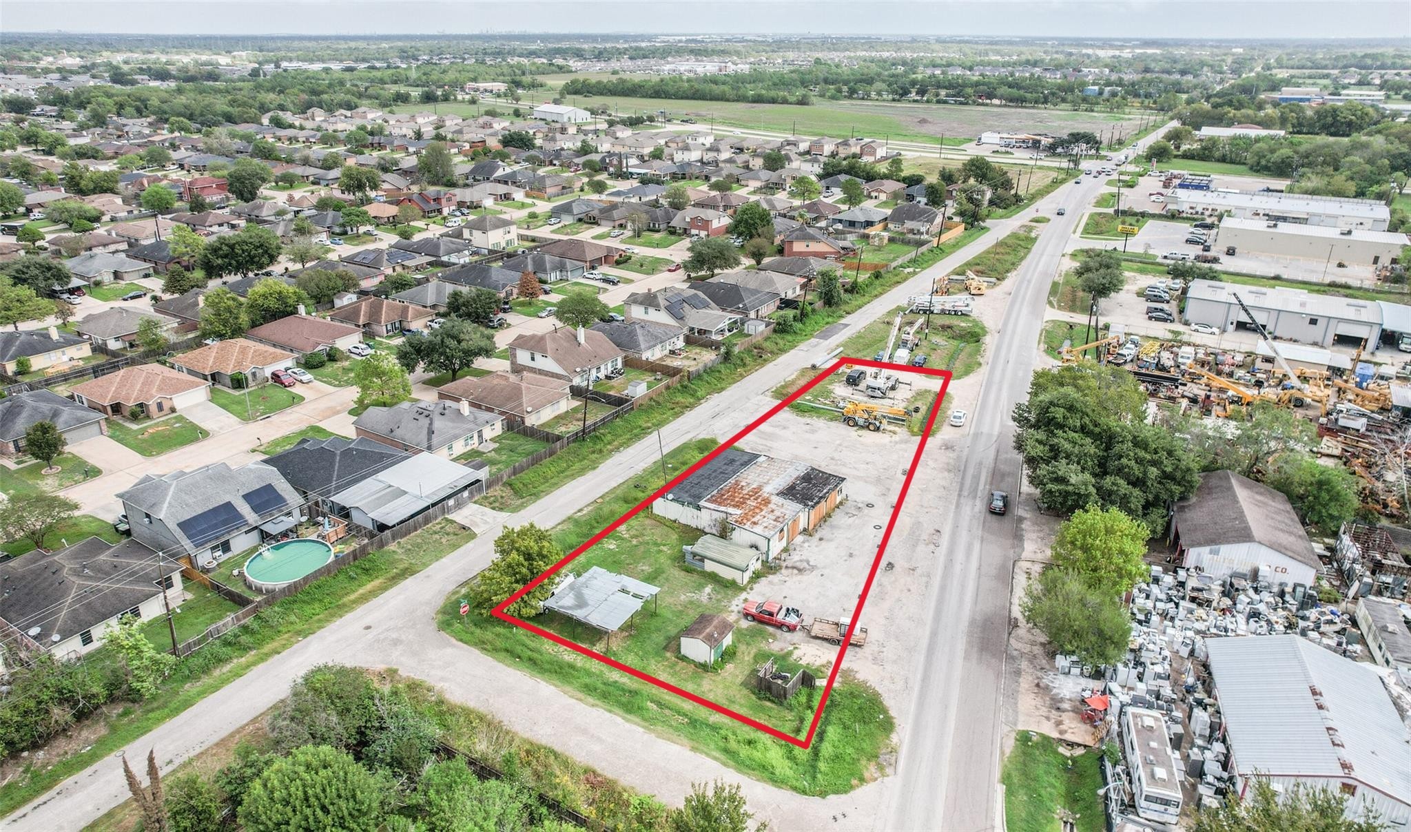 an aerial view of residential houses with outdoor space and river