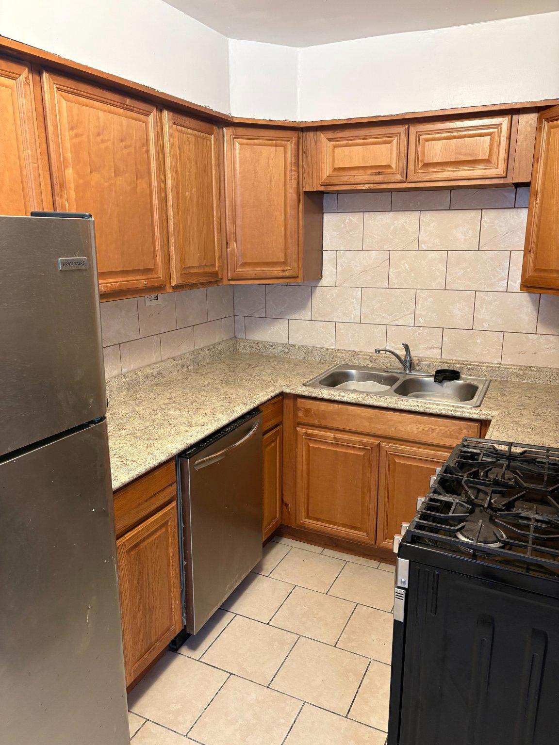 3419 Carter Lane Chester, PA 19013 - Photo 12 of 52 Unit 1-Cozy kitchen with warm wood accents.
