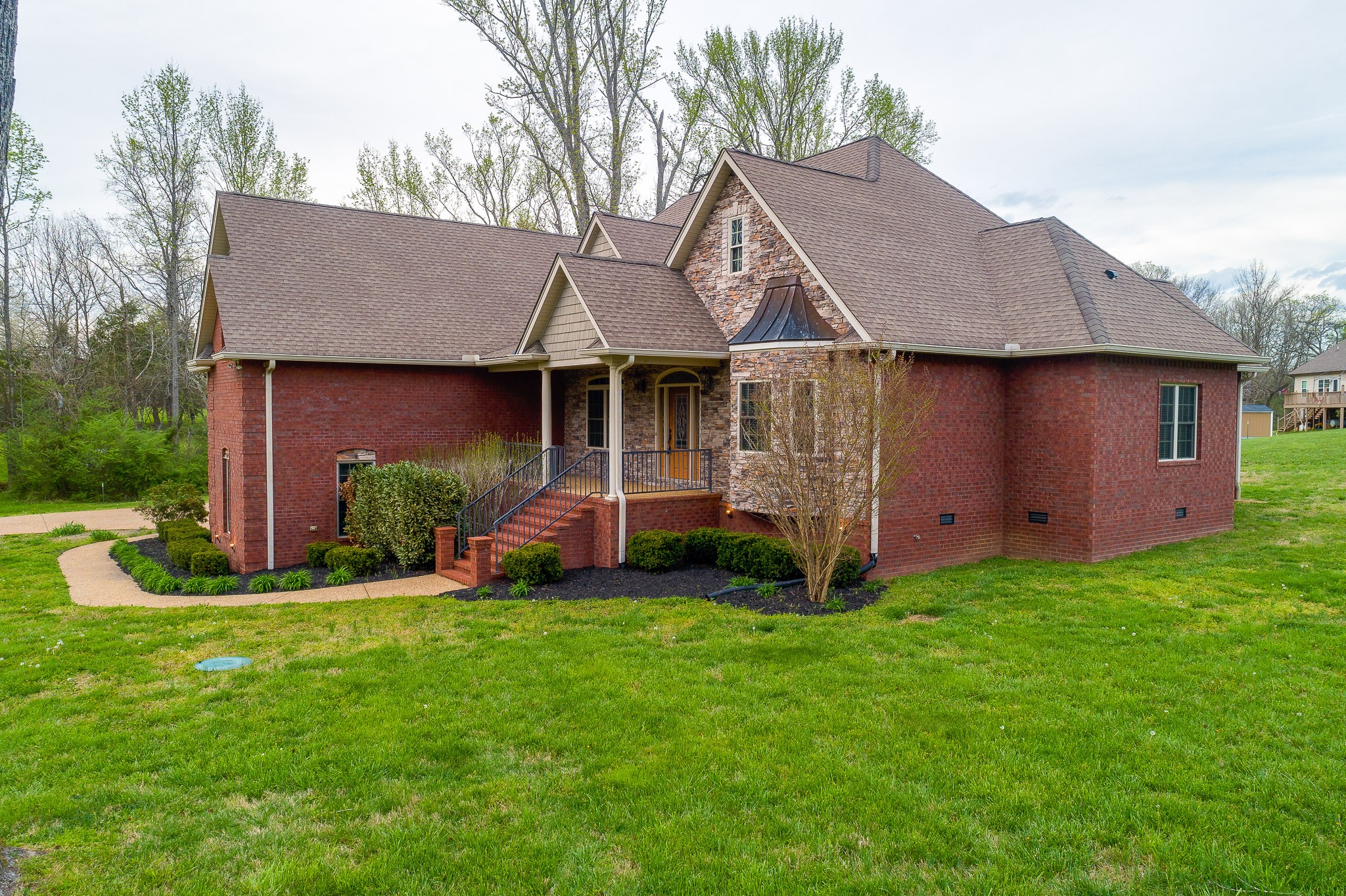 705 Deer Ridge Lane Lebanon, TN 37087 - Photo 47 of 49 a view of a barn with big yard potted plants and a large tree