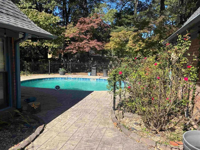 a backyard of a house with yard and outdoor seating