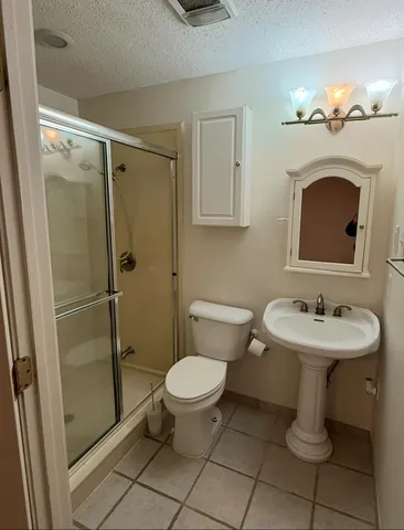a bathroom with a sink toilet and a mirror