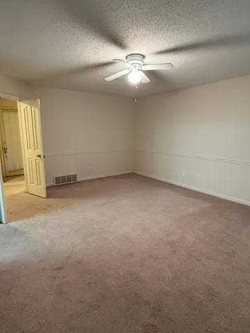 an empty room with a empty space and a ceiling fan