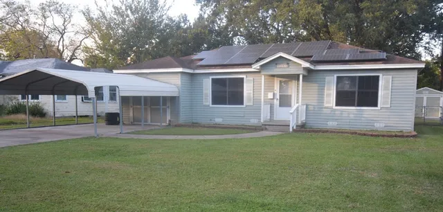 a front view of a house with a garden