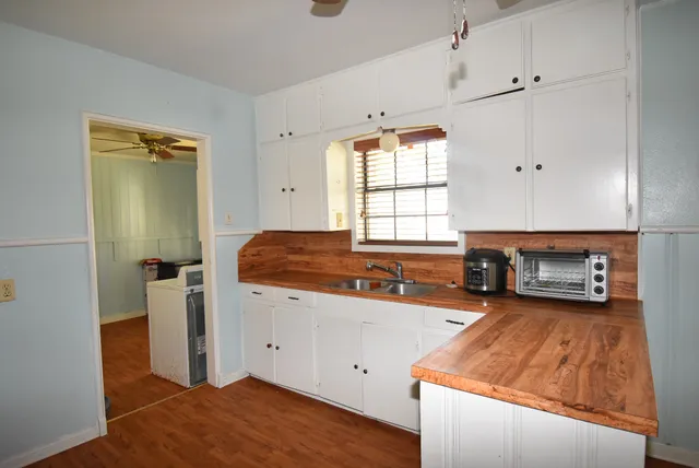 a kitchen with a refrigerator and a stove